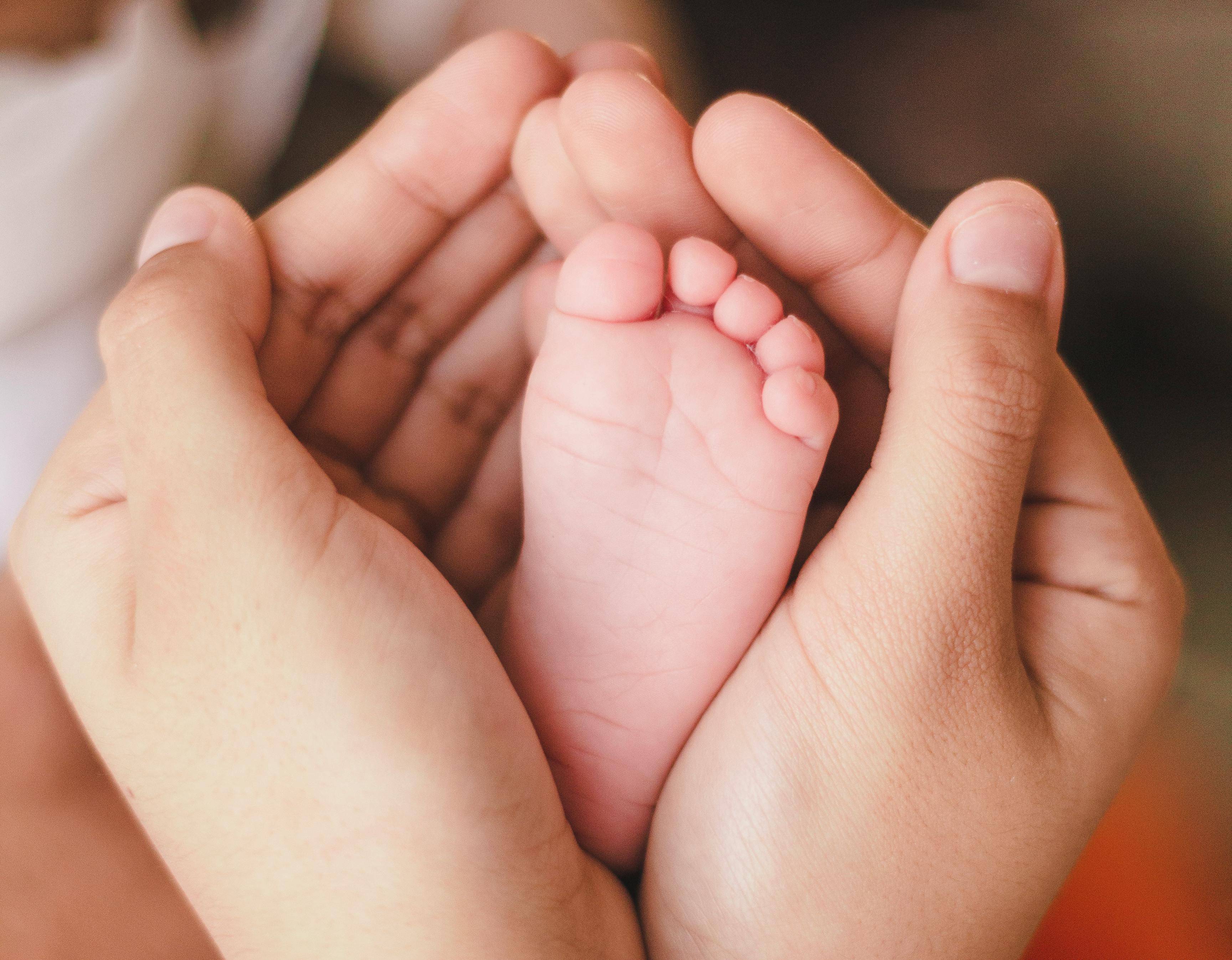 Mother holding baby's feet